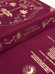 Burgundy clothbound diary with gold embossed text and designs, titled '2026 Year of Growth'.
