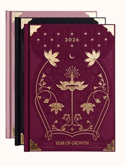 Three decorative diaries with floral designs and 'Year of Growth' text on a white background