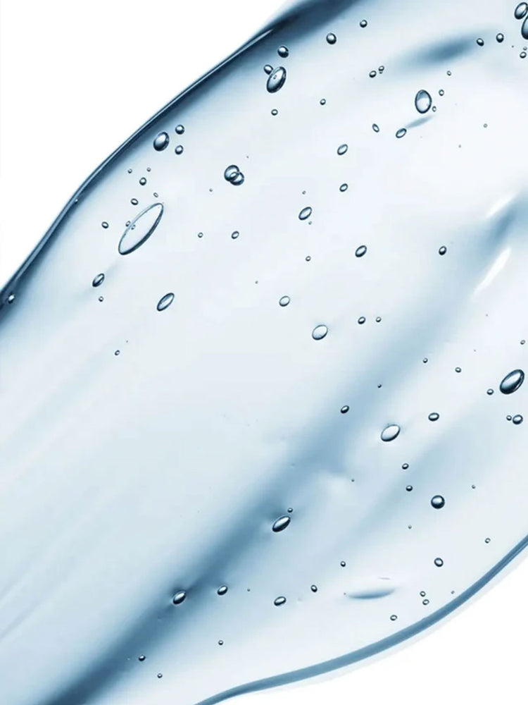 A close-up of a translucent light blue gel serum with scattered small bubbles on a white background.