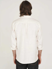 Man wearing a white hemp clothing Australia heritage button-up shirt with plastic-free buttons against a plain background