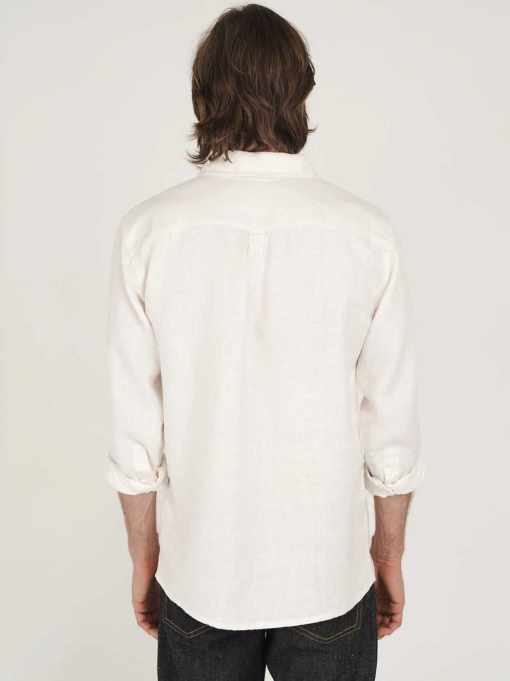 Man wearing a white hemp clothing Australia heritage button-up shirt with plastic-free buttons against a plain background