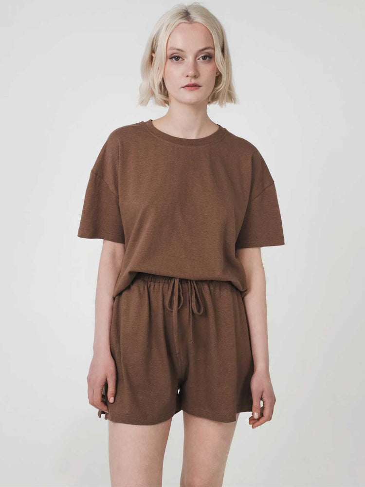 Person wearing a brown outfit on a white background
