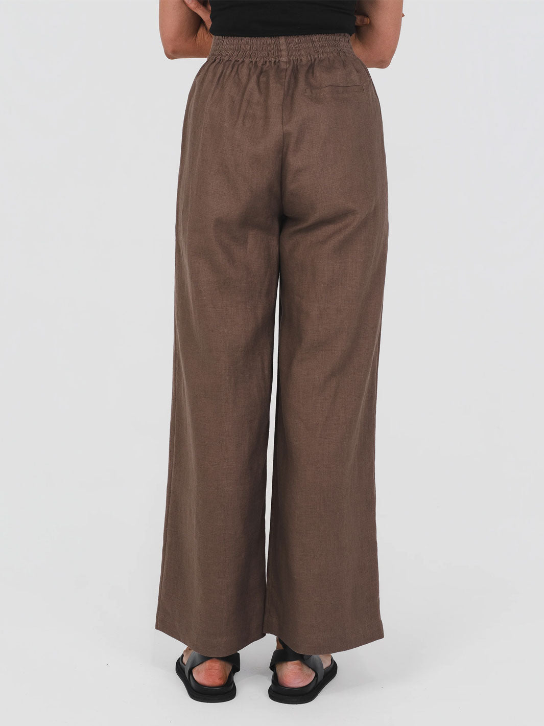 Brown wide-leg high waist hemp trousers with elasticated back waist worn by a person on a white background