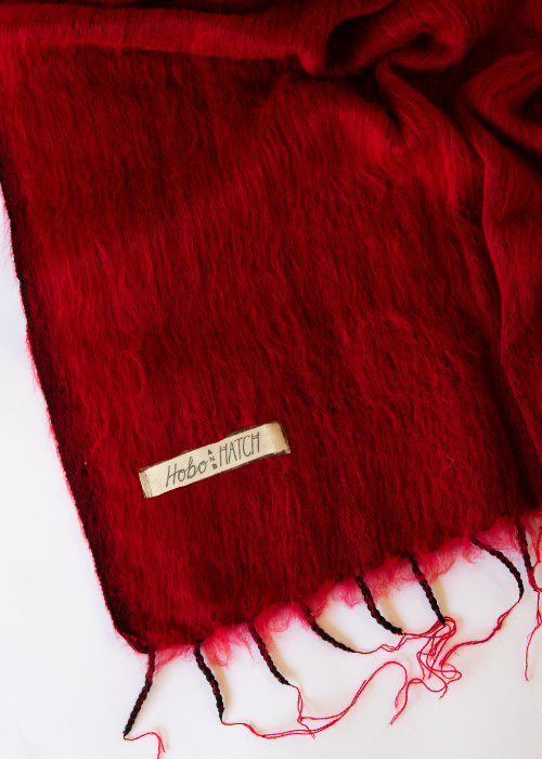 Red scarf with a brand label on a white background
