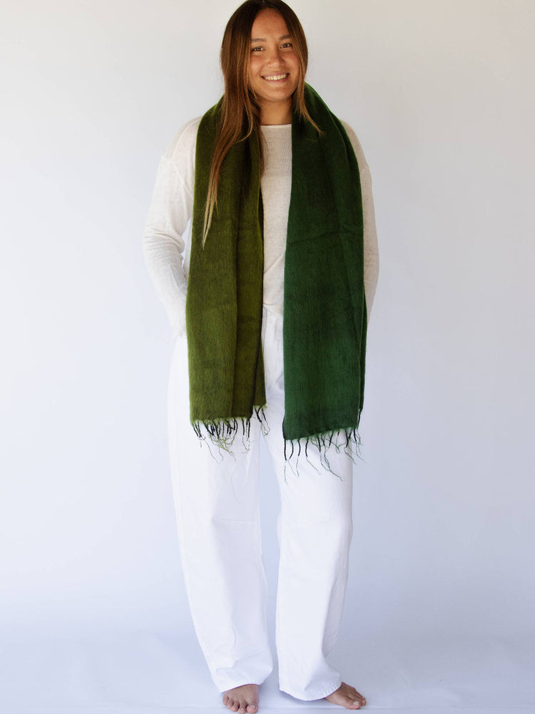 Woman wearing a green scarf against a white background