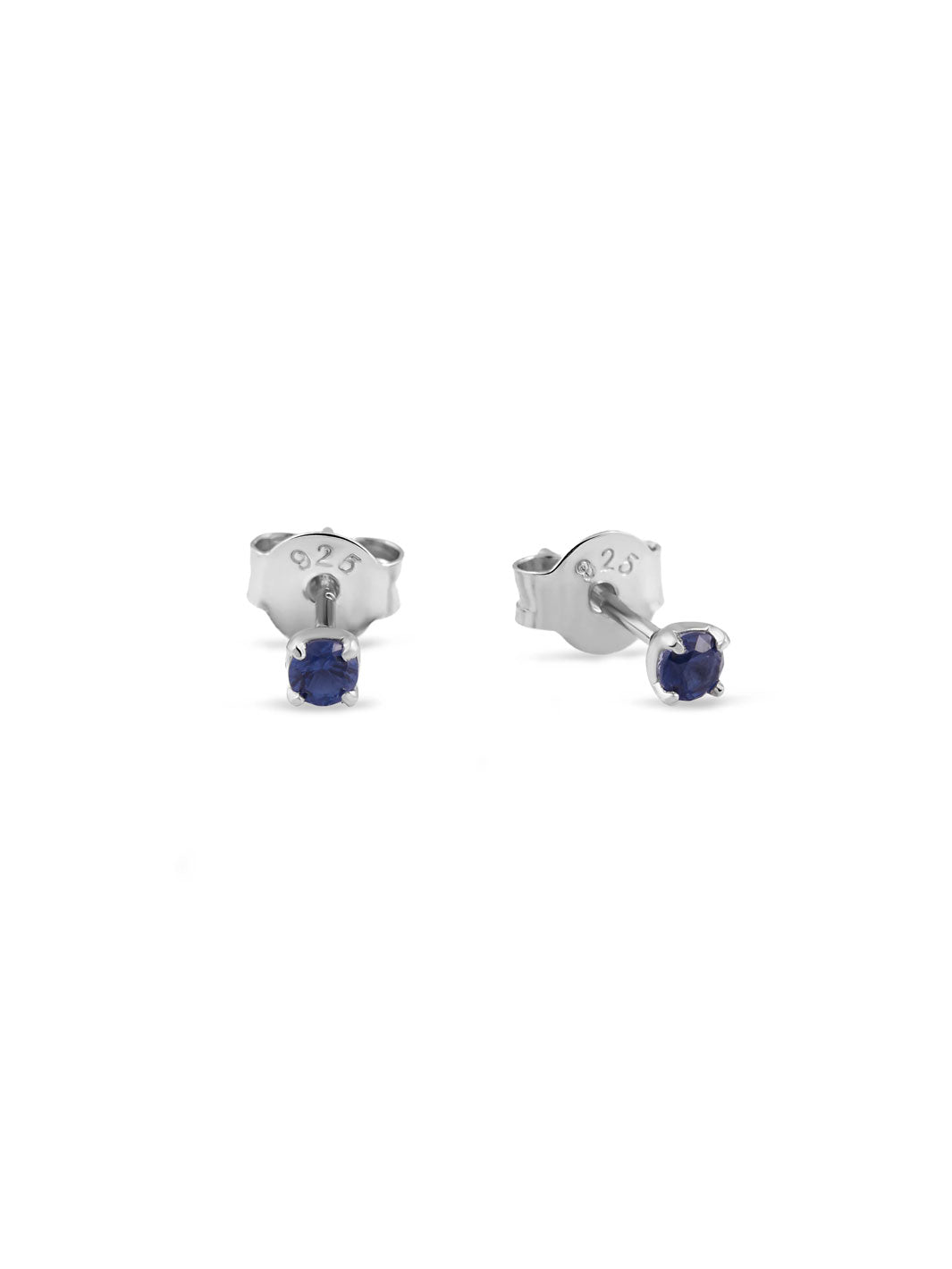 A pair of silver stud earrings with round dark blue gemstones, shown from both front and side angles on a plain white background.