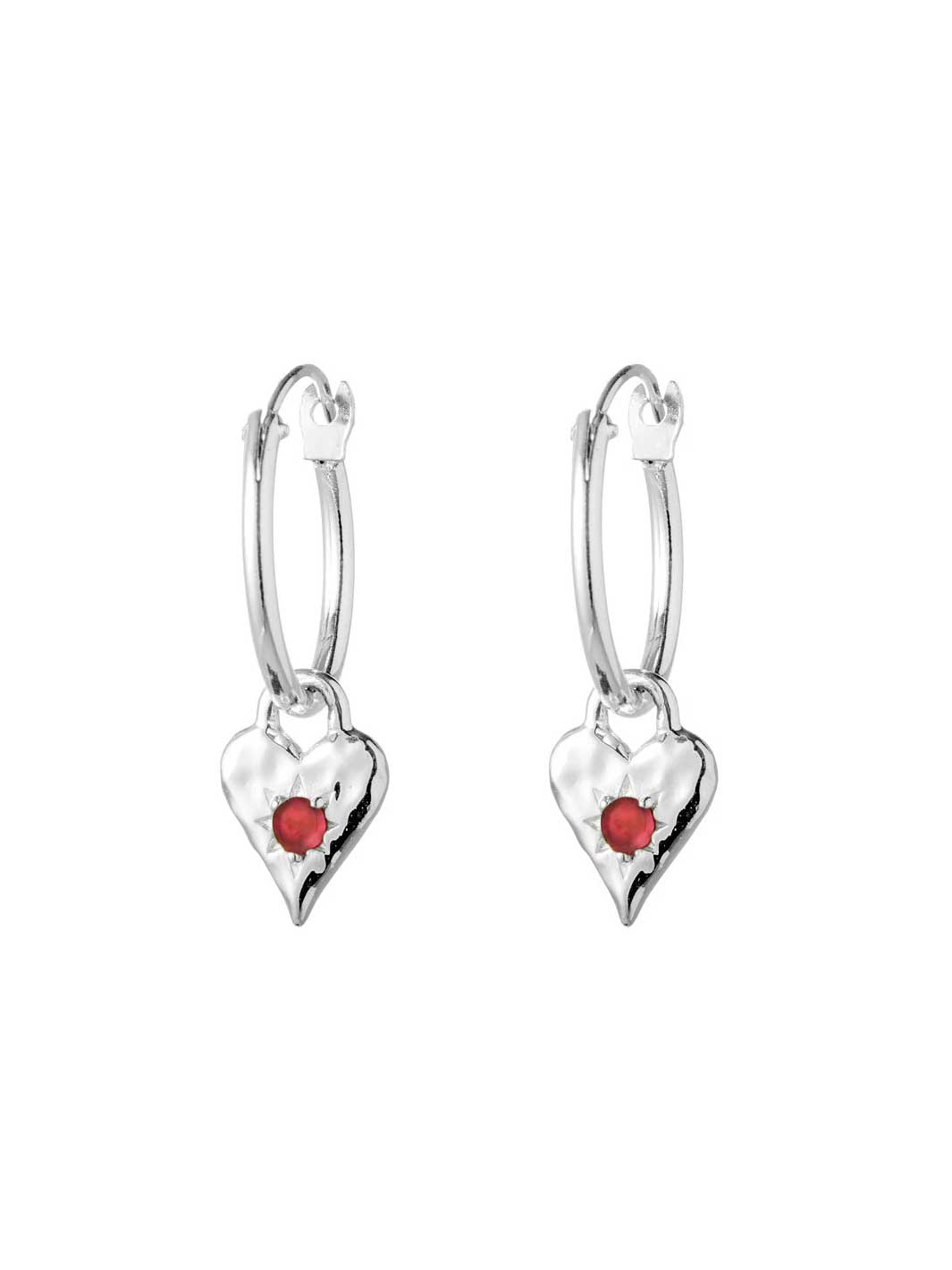 Heart-shaped earrings with red stones on a white background