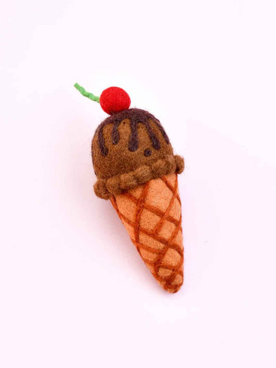 Felted ice cream cone with chocolate sauce and cherry on a white background