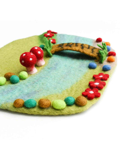 Felt fairy play mat with colourful decorations on a white background