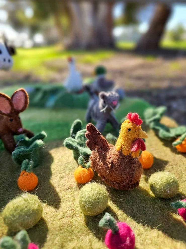 Felted garden scene with chickens, rabbits, cat and vegetables on a grassy background