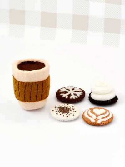Felted wool coffee cup toy and interchanging froth patterns on a white background with a checkered pattern