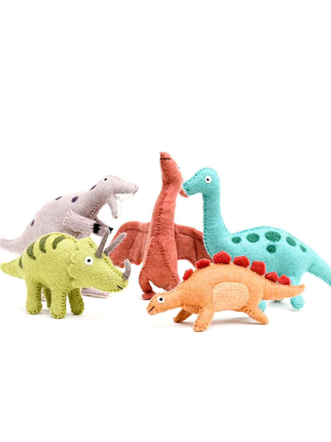 Set of colourful felt dinosaur toys on a white background