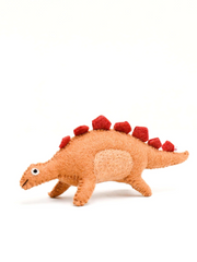 Plush orange felt toy dinosaur with red spikes on a white background