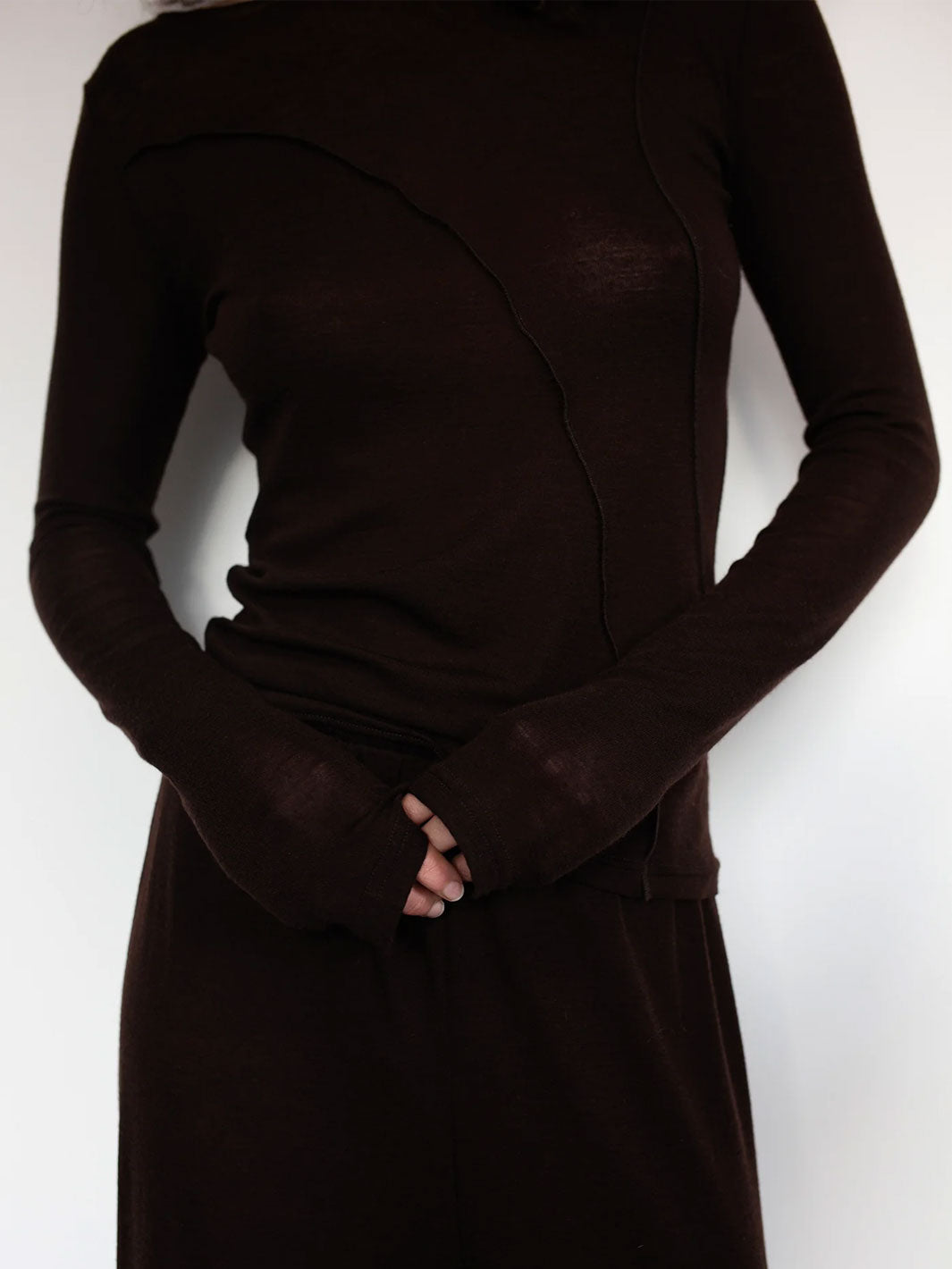 Chocolate Brown Boat Neck Stretch Knit Long Sleeve Top With Exposed Asymmetric Seam Details. By The Weft